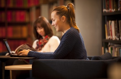 Image shows the archives reading room with two people studying. 