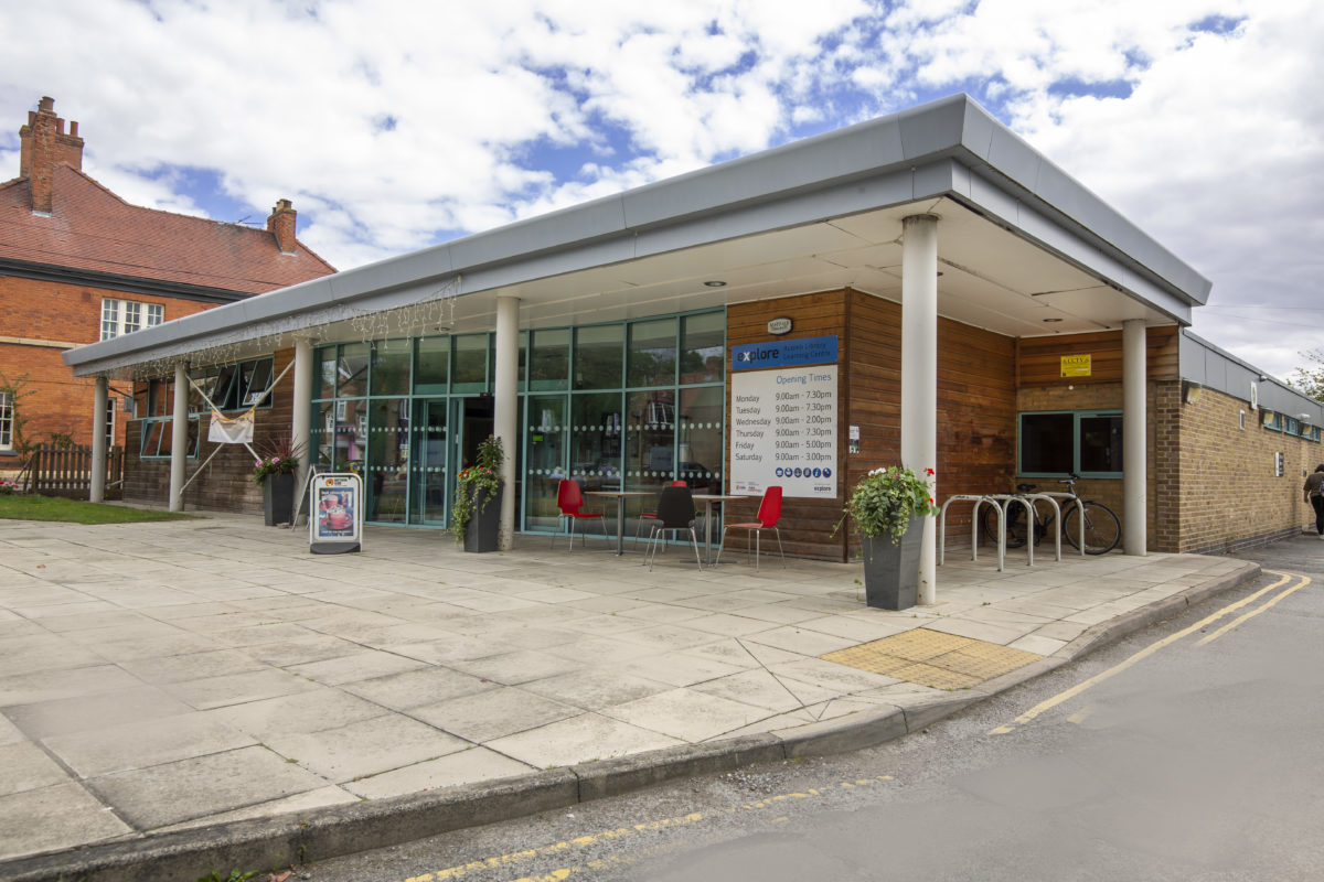 Exterior view of Acomb Explore Library on Front Streetshowing the glass front and doors into the cafe