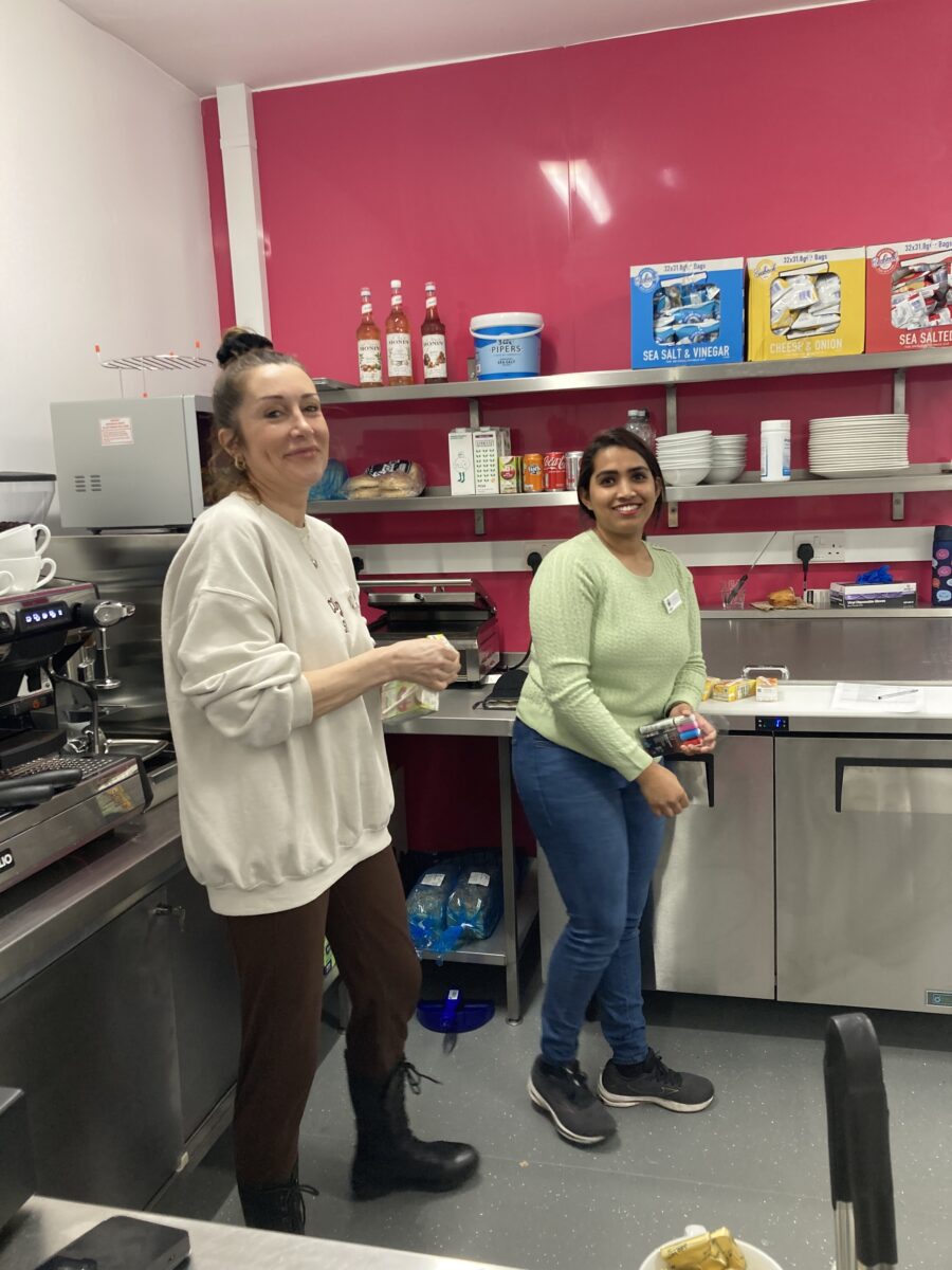 Staff in the brand new cafe at Haxby and Wigginton in front of a barista coffee machine.