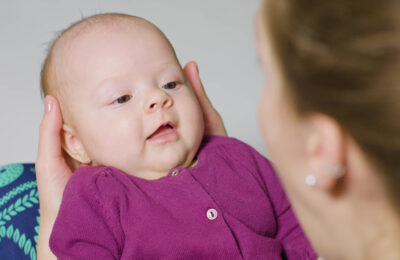 Baby looking at a woman