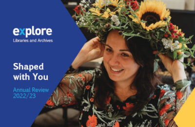 The cover of the annual reveiw showing someone wearing a crown of flowers.