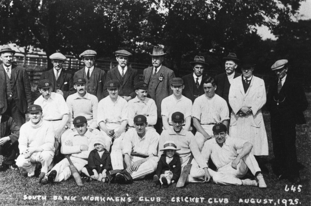 Cricket team posing with bats and mascots